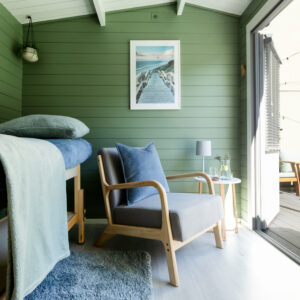 A photo of the interior of the treatment room with the doors open. A glimpse of the sunny garden is also visible.